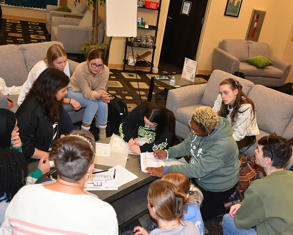 Students huddled together working on projects